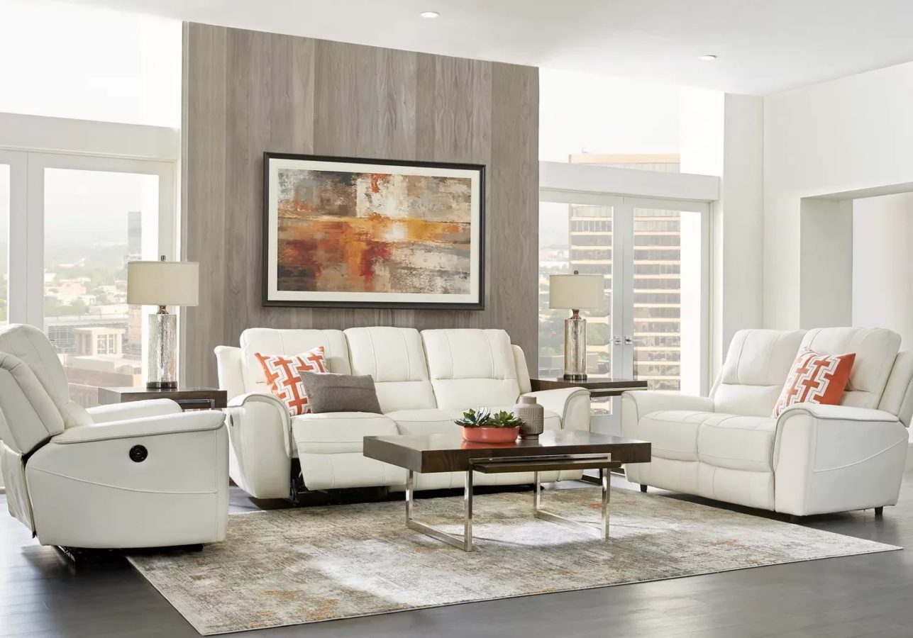 Frame a sleek, cream-colored leather sectional set with wooden tables for a refined and comfy look in a brightly lit room.